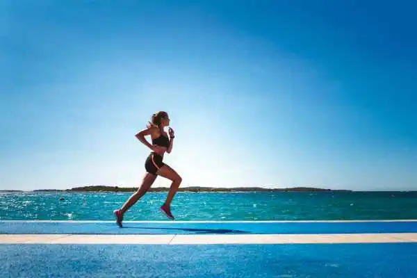 Woman running showing strong leg muscle Aldridge
